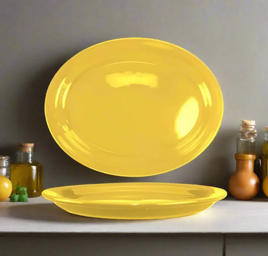 Bright yellow disposable oval plates on kitchen counter with condiment bottles in background