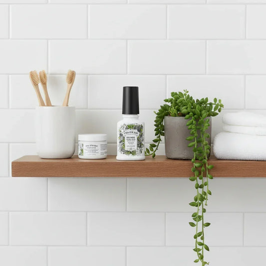 Modern bathroom shelf with bamboo toothbrushes, cosmetic jars, green potted plant, and white towels on white subway tile