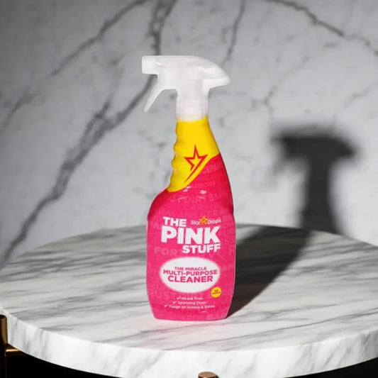 The Pink Stuff multi-purpose cleaner spray bottle on a marble table with marble background