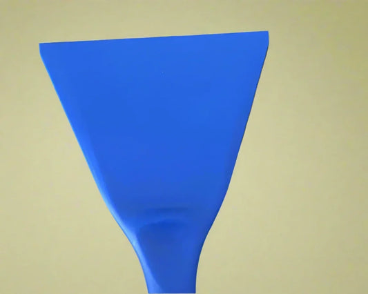 Close-up of blue plastic scraper tool against a beige background