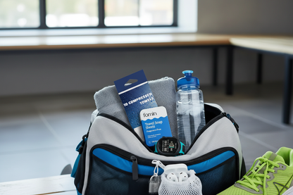 Gym bag with fragrance-free travel essentials — soap sheets, deodorant wipes and compressed towels for post-workout freshness