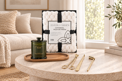 White faux fur throw blanket in gift box with soy candle, gold wick care kit, and wood tray