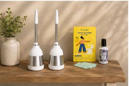 Fomin zero waste toilet cleaner strips box next to Poo-Pourri lavender vanilla odor eliminating spray.