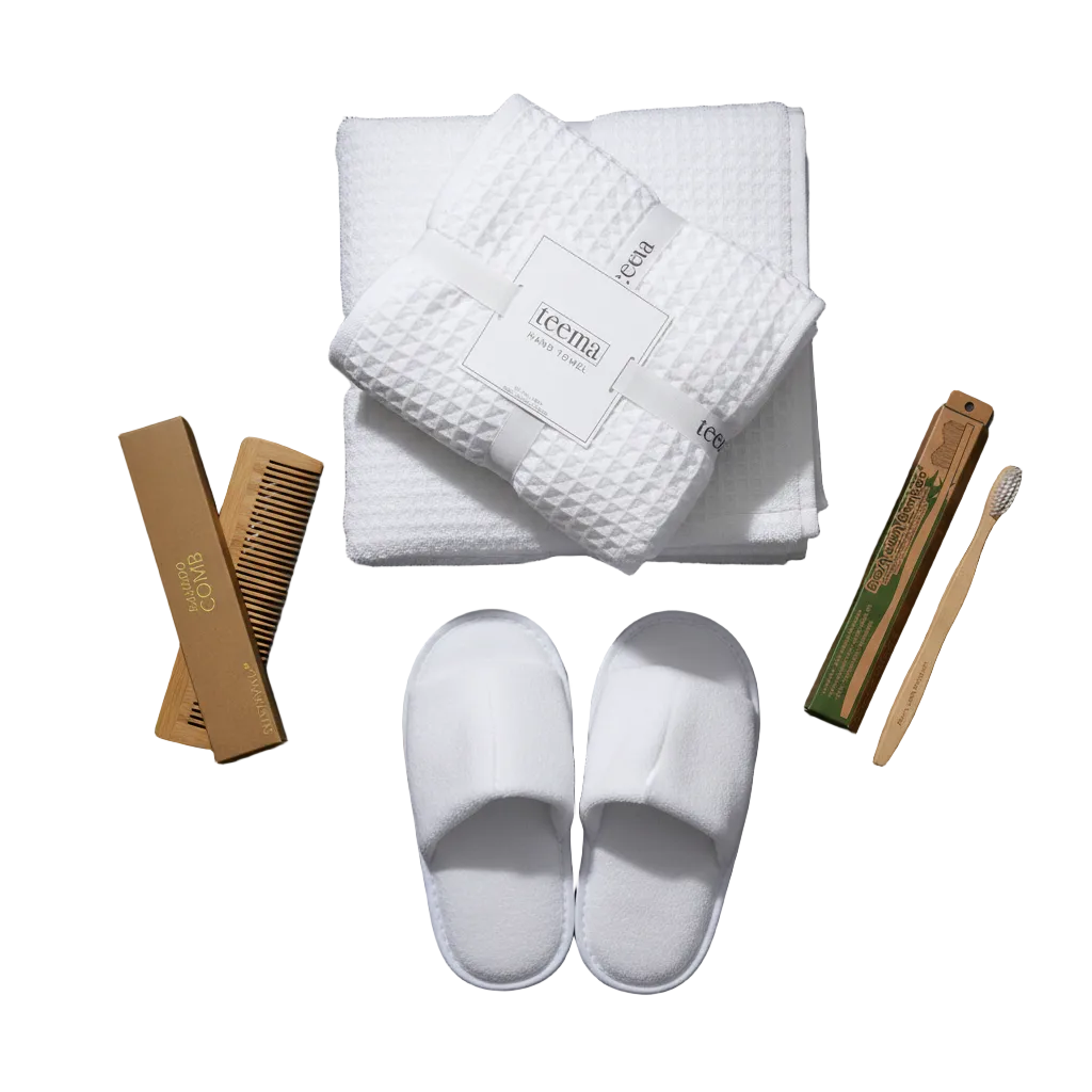 High-end white waffle cotton bath towel set with premium spa accessories and sustainable bamboo essentials, isolated on a seamless white background.