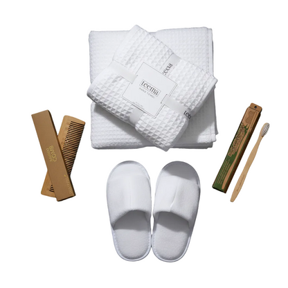 High-end white waffle cotton bath towel set with premium spa accessories and sustainable bamboo essentials, isolated on a seamless white background.